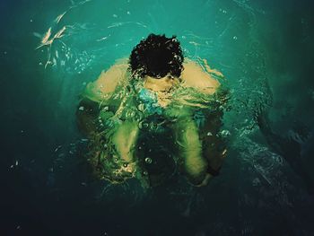 High angle view of man swimming in sea