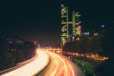 Light trails on road in city at night
