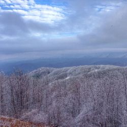 Scenic view of mountains against cloudy sky