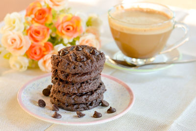 Dark chocolate cookies with chocolate chips on dish served in party.