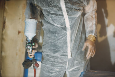 Midsection of man standing in factory