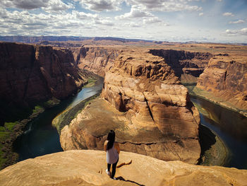 Rear view of woman standing at horseshoe bend