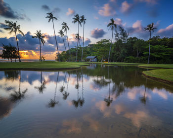 Scenic view of lake against sky at sunset
