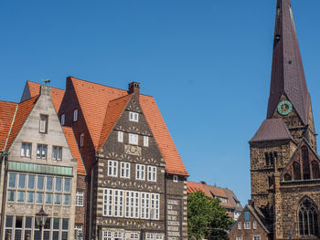 Low angle view of buildings against blue sky