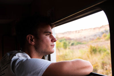 Close-up of man looking through car window