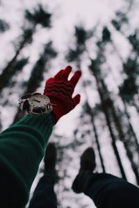 Close-up of human hand wearing alarm clock gesturing outdoors