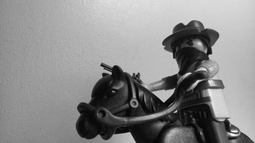 Close-up of a horse statue against wall