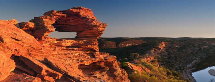 Rock formations on mountain against clear sky