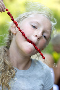 Girl eating wild strawberries