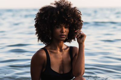 Portrait of young woman looking at sea