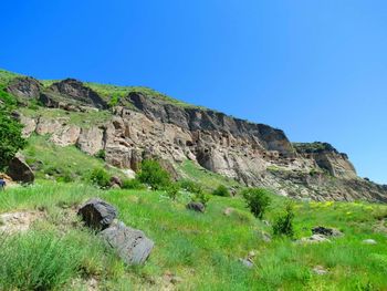 Scenic view of mountains against clear blue sky