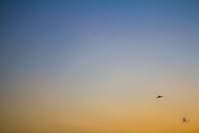 Airplane flying against clear sky