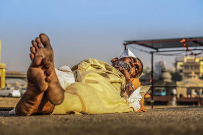 Midsection of man in city against sky