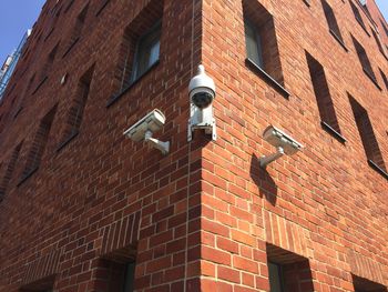 Low angle view of street light against building