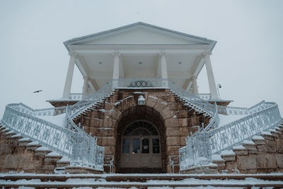 Low angle view of building against sky during winter