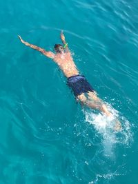 High angle view of man swimming in sea