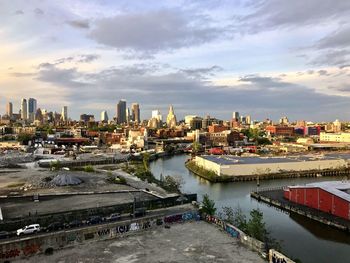 High angle view of river by buildings in city against sky