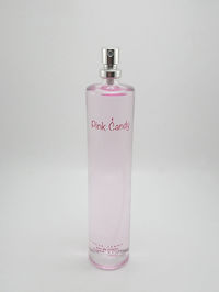 Close-up of pink bottle against white background