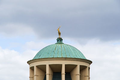 Low angle view of bell tower against sky