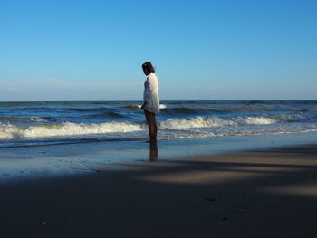 Full length of man standing on beach