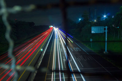 High angle view of light trails on road at night