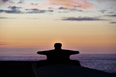 Silhouette mooring bite at beach during sunset