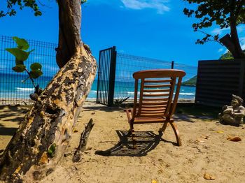 Chairs on beach against sky