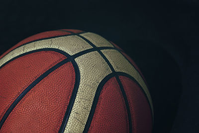 Close-up of basketball against black background