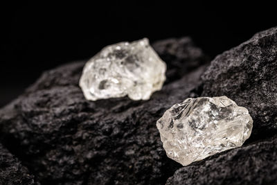 Close-up of stones on rock against black background