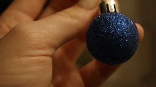 Close-up of hand holding christmas decoration