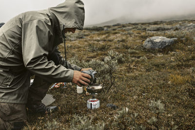 Hiker using camping stove
