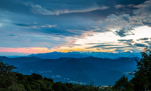 Scenic view of mountains against sky at sunset