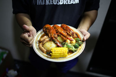 Midsection of man holding food