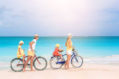 Bicycles on beach against sky