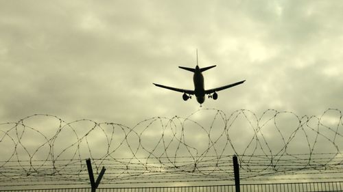 Airplane flying against sky