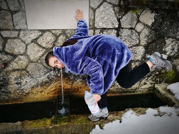 Full length of girl with arms raised in water