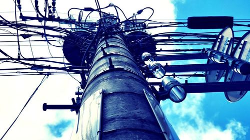 Low angle view of electricity pylon against sky