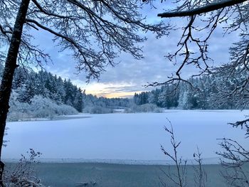 Scenic view of frozen lake against sky during winter
