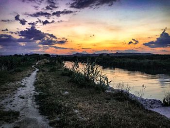 Scenic view of lake against sky during sunset