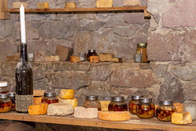 Wine bottles on shelf at home