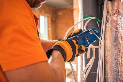 Midsection of worker working at construction site