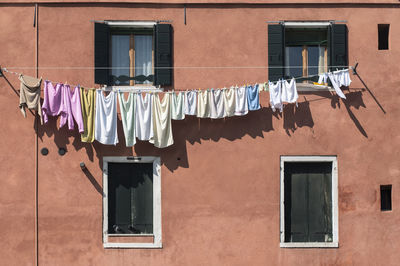 Low angle view of clothes drying outside house