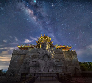 Low angle view of statue against sky at night