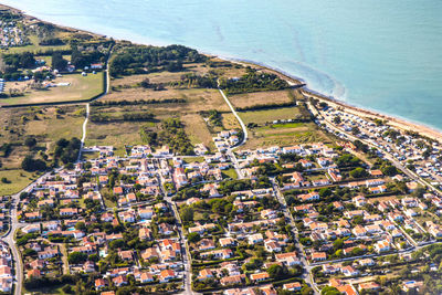 High angle view of townscape by sea