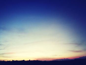 Scenic view of landscape against sky at sunset