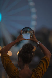 Portrait of woman holding crystal ball with reflection