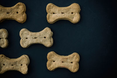 Close-up of dog bone over blue background