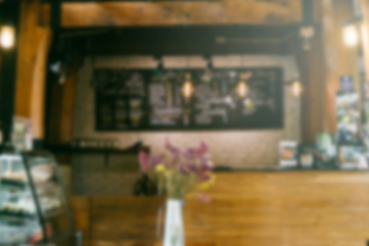 CLOSE-UP OF FLOWER VASE ON TABLE AT RESTAURANT