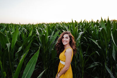 Portrait of smiling young woman standing in farm