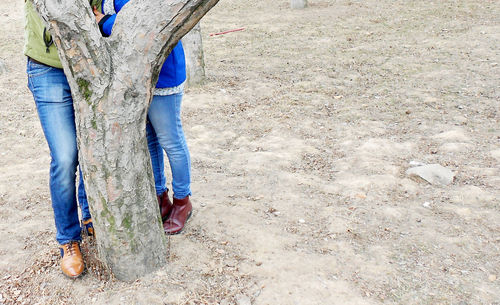 Low section of woman standing on field